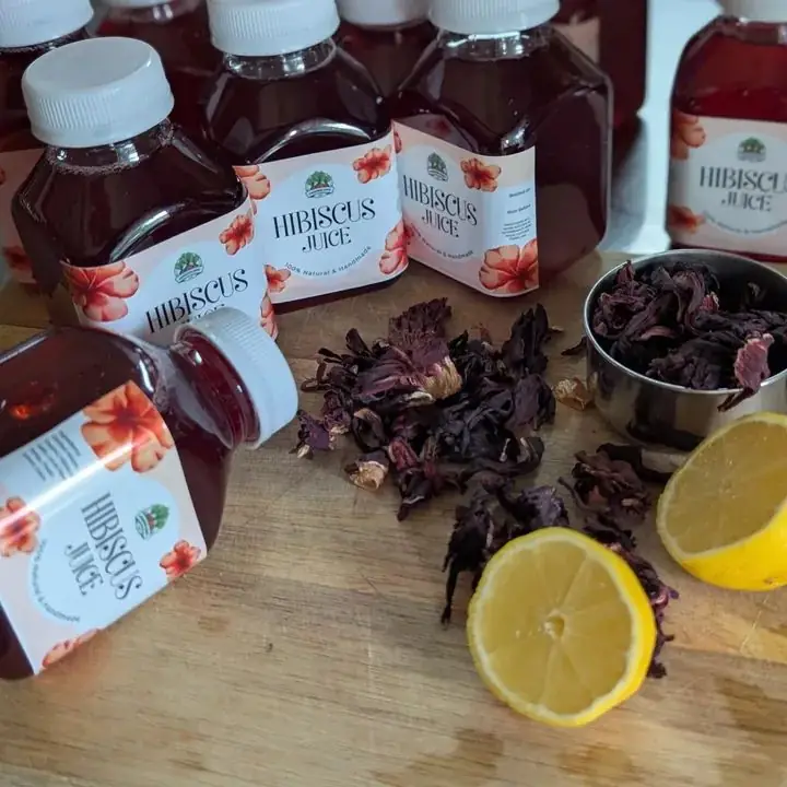Bottles of Cameron Juice Hibiscus juice with dried hibiscus flowers and fresh lemon